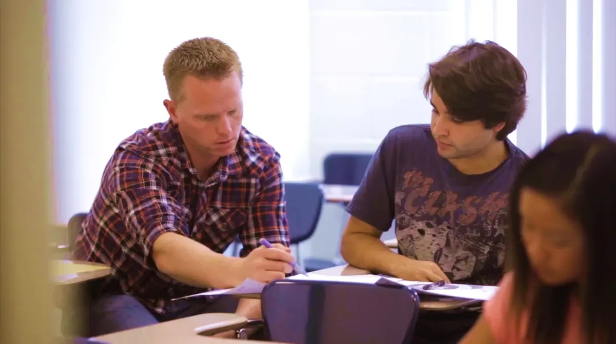 An instructor working through a problem with a student